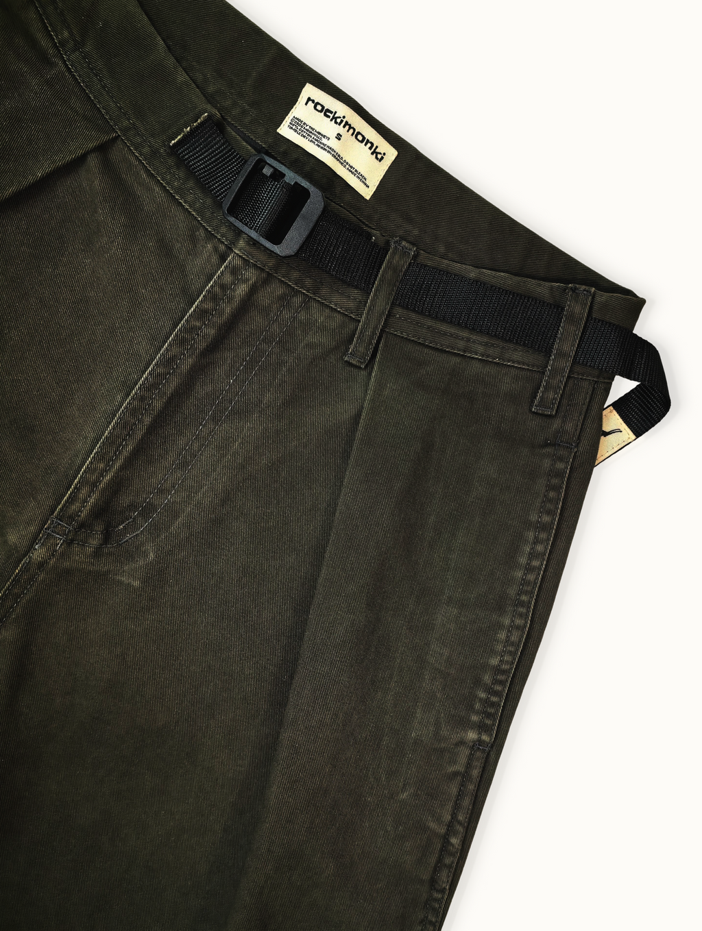 Dark green pants with a belt and visible brand label on a white background